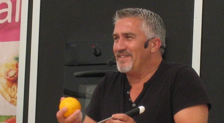 Paul Hollywood zesting a lemon at a food-themed event