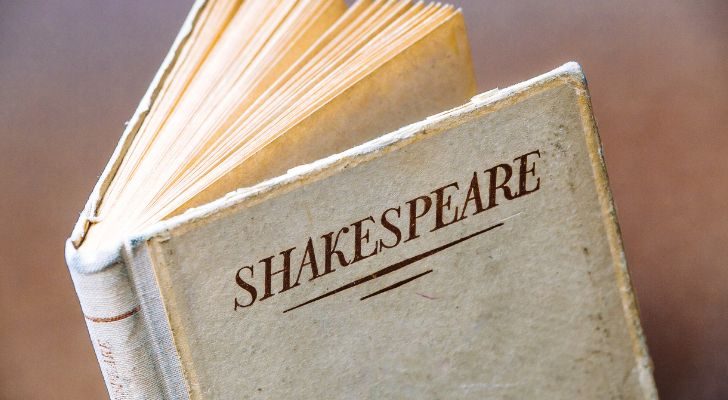 An old white book with the title "Shakespeare" written on the cover