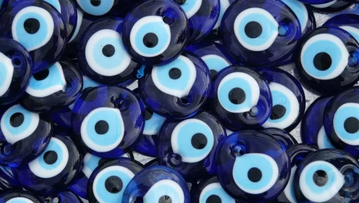 A collection of blue Nazar, or evil eye charms, commonly used for protection in various cultures.