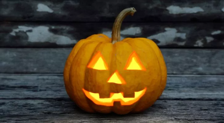 A typical Jack O'Lantern carved from a pumpkin with a candle inside