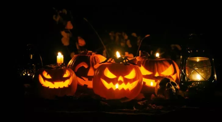 A collection of Jack O'Lanterns with various faces carved into them