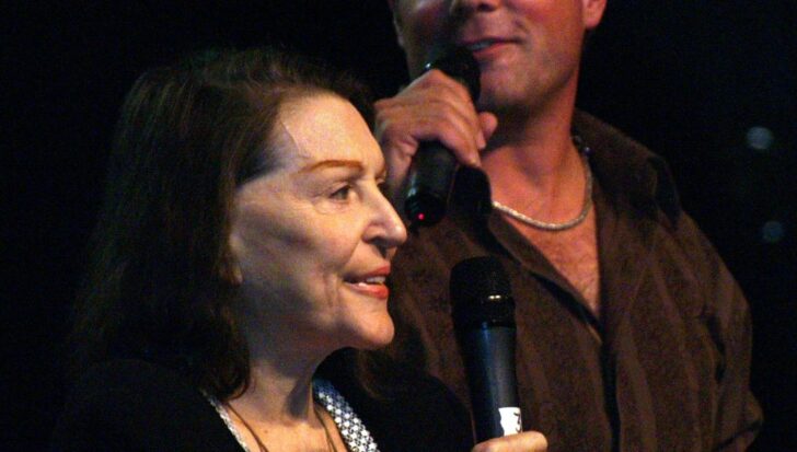 Majel Barrett-Roddenberry holding a microphone with another person nearby