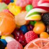 Colorful assortment of hard candies, including lollipops and gummies, with bright colors and diverse shapes