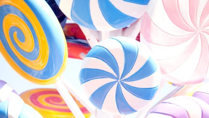 Colorful swirl lollipops in various shades including blue, yellow, and pink