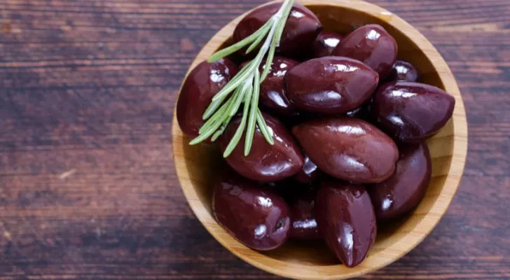 A small bowl of dark purple Kalamata olives