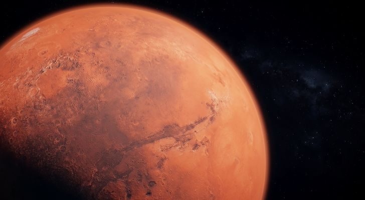 An image of Mars' surface in a reddish-orange hue