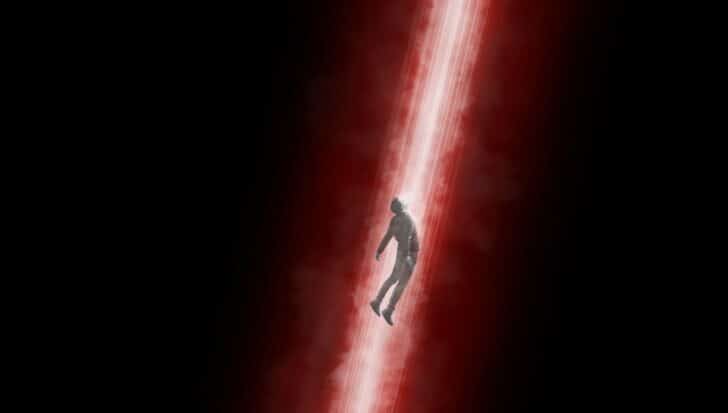 A figure being transported through a red and white beam