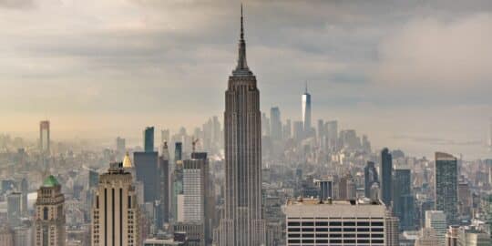 The Empire State Building amidst the New York City skyline with surrounding skyscrapers