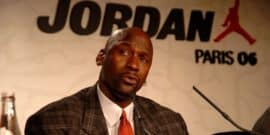 Michael Jordan speaking at a press event with "Jordan Paris 06" logo in the background