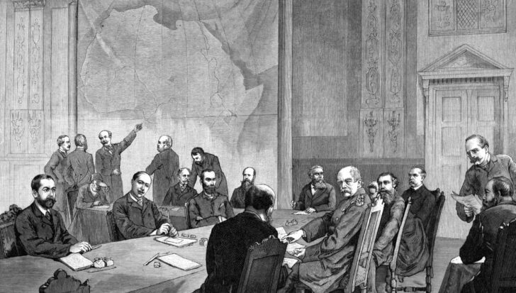 A historical drawing showing a group of European men in formal attire gathered around a table, with a large map of Africa on the wall